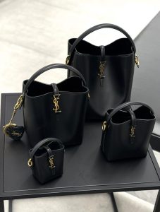 woman carrying medium size leather handbag