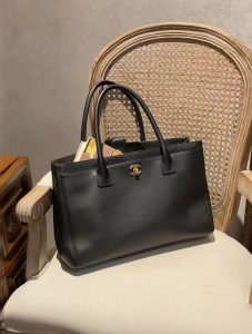women carrying structured handbag